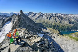 Man and woman standing at summit of Richterspitze, Richterspitze, Reichenspitze group, Zillertal Alps, Tyrol, Austria