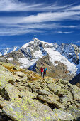 Two persons hiking, Dreiherrenspitze in background, Natural Park Zillertal Alps, Dreilaendertour, Zillertal Alps, South Tyrol, Italy
