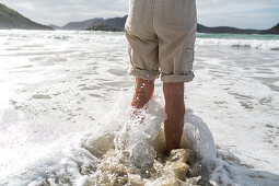 standing in surf water on beach, New Zealand