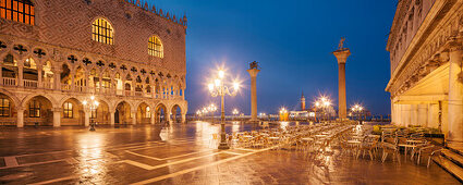 Panorama of St. Mark's Square with the illuminated facade of the Doge's Palace, lanterns and columns with Markus Lion and the San Todaro statue in blue night, Biblioteca Nazionale Marciana right, Church of San Giorgio Maggiore in the background, Piazzetta