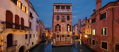 Panorama overlooking a illuminated house between channels Rio di San Giovanni Laterano and Rio de la Tetta in blue twilight, Castello, Venice, Veneto, Italy