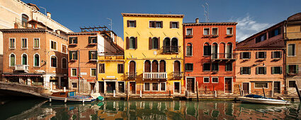 Panorama with colorful houses along the canal Rio di Santa Fosca and boats in the morning sun and blue sky, Cannaregio, Venice, Veneto, Italy