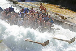 People on a traditional wooden raft on a shute in Thalkirchen, Munich, Upper Bavaria, Bavaria, Germany