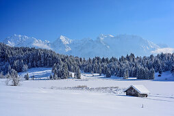 Snow covered barn house at lake Geroldsee with Karwendel range i, lake Geroldsee, Werdenfels, Upper Bavaria, Bavaria, Germany
