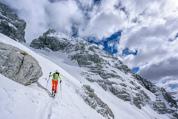 Woman backcountry skiing ascending towards Forca del Palone, Forca del Palone, Julian Alps, Friaul, Italy