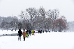 Walking during snow fall on a Sunday Afternoon, Eisbach, English Garden, Munich, Germany