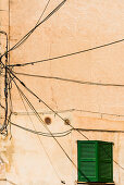 A typical unusual wiring on a house wall, Valldemossa, Mallorca, Spain