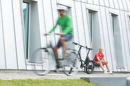 Man and woman on eBikes, City,  Munich, Bavaria, Germany