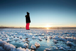 Kid on a frozen Lake Starnberg, Muensing, Upper Bavaria, Bavaria, Germany