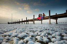 Kids on  Jetty at Frozen Lake Starnberg, Ambach, upper bavaria, bavaria, Germany