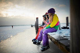 Kids on a jetty on frozen Lake Starnberg, Ambach, upper Bavaria, Bavaria, Germany