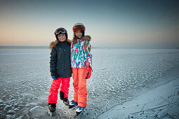 Kids on frozen Lake Starnberg, Muensing, upper Bavaria, Bavaria, Germany