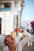 young girl eating a slice of pizza,  Conil de la Frontera, andalusia, southwest coast spain, atlantc, Europe