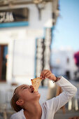 young girl eating a slice of pizza,  Conil de la Frontera, andalusia, southwest coast spain, atlantc, Europe