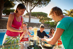 2 Families having Dinner at Poolside in a holiday home,  andalusia, southwest coast spain, atlantc, Europe