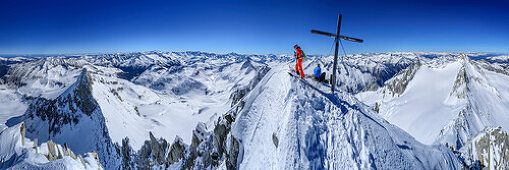 Panorama with two persons backcountry skiing at summit of Reichenspitze, Reichenspitze, Zillertal Alps, Tyrol, Austria