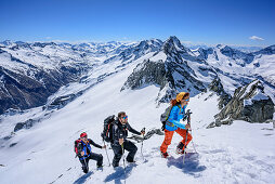 Three persons backcountry skiing ascending towards Grundschartner, Grundschartner, Zillertal Alps, Tyrol, Austria