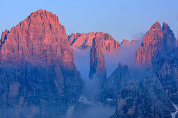 Rock crags of Brenta group with Guglia di Brenta in alpenglow, from Croz dell' Altissimo, Brenta group, UNESCO world heritage site Dolomites, Trentino, Italy