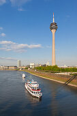 Excursion ships entering Medienhafen, view over the Rhine river to the television tower, Medienhafen, Duesseldorf, North Rhine-Westphalia, Germany