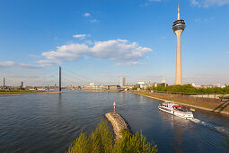 Excursion ship on the Rhine river, view to Rheinknie bridge and television tower, Duesseldorf, North Rhine-Westphalia, Germany