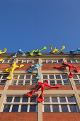 Flossi figures at the facade of the Roggendorf house, Medienhafen, Duesseldorf, North Rhine-Westphalia, Germany