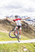 Young man on his racing cycle at the Kitzbühler Alps, Kitzbühlerhorn, Tyrol, Austria