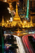 Overhead of illuminated Sule Pagoda and streaks of car lights on Sule Pagoda Road seen from Sakura Tower at night, Yangon, Yangon, Myanmar