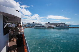 Couple on deck of cruise ship MS Romantic Star (Reisebüro Mittelthurgau) as it departs harbor, Split, Split-Dalmatia, Croatia