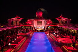 Pool party on Pooldeck of cruise ship Mein Schiff 6 (TUI Cruises) at night, Baltic Sea, near Denmark
