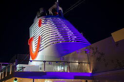 TUI logo on chimney of cruise ship Mein Schiff 6 (TUI Cruises) at night, Baltic Sea, near Denmark