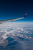 Aerial of wing and winglet of Condor B-767-300ER (D-ABUB) during flight DE 2062 from Frankfurt to Las Vegas with mountains and glacier on eastern coast of Greenland, above Greenland