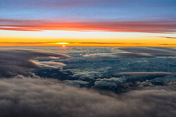 aerial shot above a cloud layer during sunset, italien alps