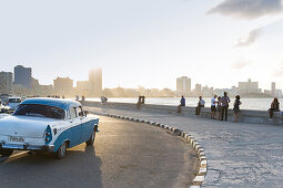 Blue oldtimer, driving along Malecon, historic town center, old town, Habana Vieja, Habana Centro, family travel to Cuba, holiday, time-out, adventure, Havana, Cuba, Caribbean island