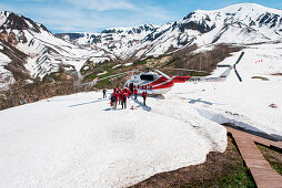 A group of German tourists arrive via helicopter in the Valley of Geysers (UNESCO World Heritage Site), near Petropavlovsk-Kamchatsky, Kamchatka, Russia, Asia