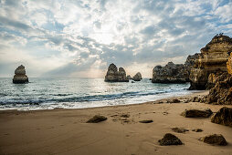 Rocky coast with beach and red rocks, Praia do Camilo, Lagos, Algarve, Portugal