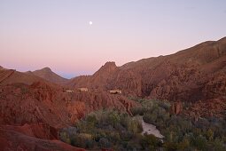 Rockformation in the Dadés gorge with casbah and poplar trees,  small road beside a river passing the gorge, High Atlas, Morocco