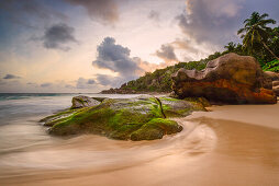 water washes around the rocks of Intendance beach, Mahé, Seychelles