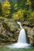 Waterfall with trees in autumn colours in background, Kuhflucht waterfall, Farchant, Ester Mountains, Bavarian Alps, Upper Bavaria, Bavaria, Germany