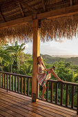 BELIZE, Punta Gorda, Toledo, Belcampo Belize Lodge and Jungle Farm, a guest enjoying all the amenities of the Ridge Suite, which offers stunning views, a private screened porch, outdoor soaking tubs and access to a salt water infinity pool