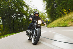 older man riding his motorbike