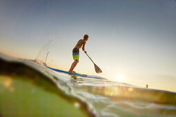 Stand Up Paddler on Lake Starnberg,  Young Boy SUP, Lake Starnberg, Bavaria, Germany