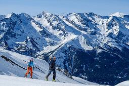 Man and woman backcountry-skiing ascending towards Rastkogel, Zillertal Alps in background, Rastkogel, Tuxer Alps, Tyrol, Austria
