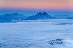 Hohensalzburg Fortress rising above sea of fog in valley of Salzach, Hochstaufen in background, from Gaisberg, Salzkammergut, Salzburg, Austria