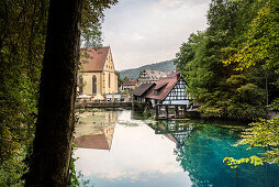the „Blautopf“ in Blaubeuren, view at monastry, hammer mill and histroic town centre, Alb Danube District, Swabian Alb, Baden-Wuerttemberg, Germany