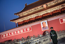 policeman or guard in front of portrait of Mao Zedong at Tiananmen Gate which is the gate to the Forbidden City, Beijing, China, Asia
