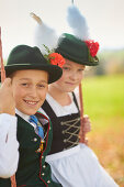 Kids in  Traditional bavarian clothes on a swing, Ammerland, bavaria, Germany