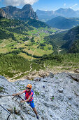 Woman climbing fixed-rope route Pisciadu, fixed-rope route Pisciadu, Sella range, Dolomites, UNESCO World Heritage Site Dolomites, South Tyrol, Italy