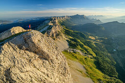 Woman while hiking on the mountains of the Vercors looks with mouche role in the background, from the Grand Veymont, Vercors, Dauphine, Dauphine, Isère, France