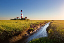 Priel through the salt marshes at the lighthouse Westerhever, North Sea, Schleswig-Holstein, Germany