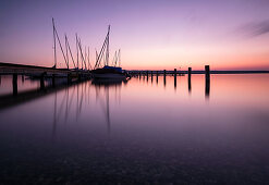 Pier with sailing boats at sunset at Ammersee, long exposure, Ammersee, Alpine foothills, Bavaria, Germany